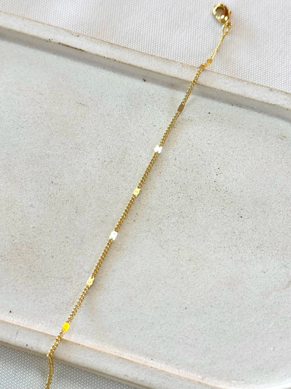 Pulseira grumet com chapinhas redondas